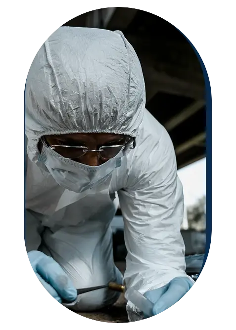 Forensic investigator in protective suit collecting evidence at a crime scene